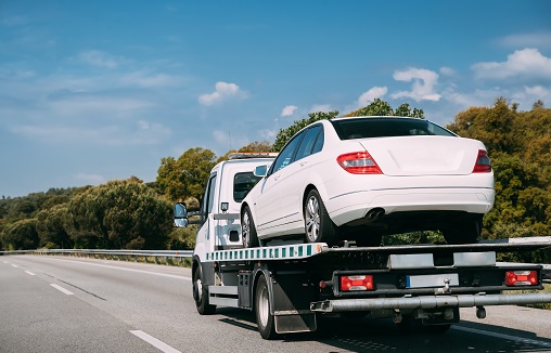 Car Service Transportation Concept. Tow Truck Transporting Car Or Help On Road Transports Wrecker Broken Car. Auto Towing, Tow Truck For Transportation Faults And Emergency Cars . Tow Truck Moving In Motorway Freeway Highway